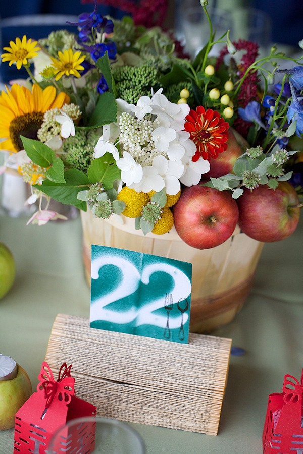 country inspired centerpiece with apples and flowers - paper table numbers - wedding photo by top Philadelphia based wedding photographers Langdon Photography